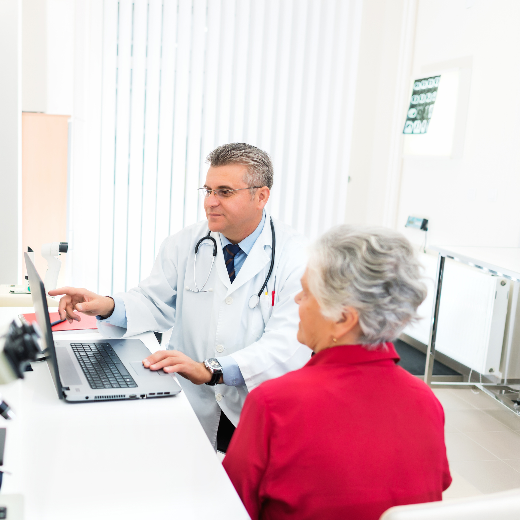 Medical professional meeting with senior