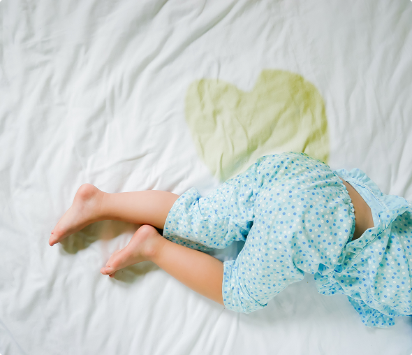 Child in pajamas on wet bed