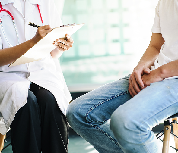 Healthcare professional taking notes during appointment
