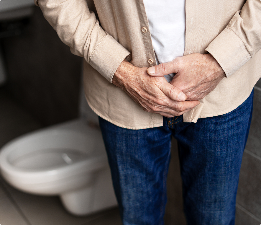Person standing in bathroom, hands clasped