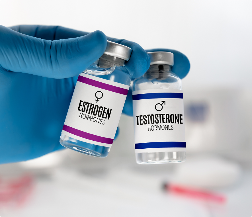 Gloved hand holding hormone vials