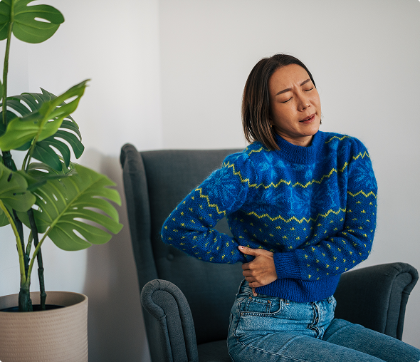 Woman holding her side in pain