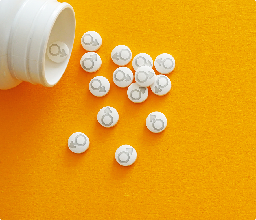 Medication tablets on vibrant orange surface