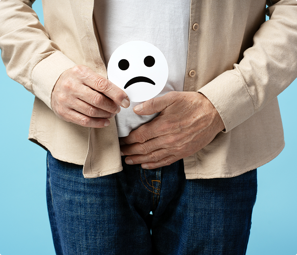 Man holding sad face sign over stomach