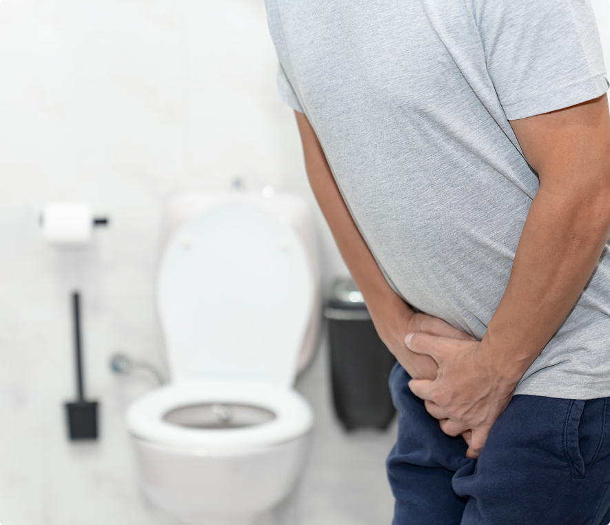 Person holding stomach in bathroom