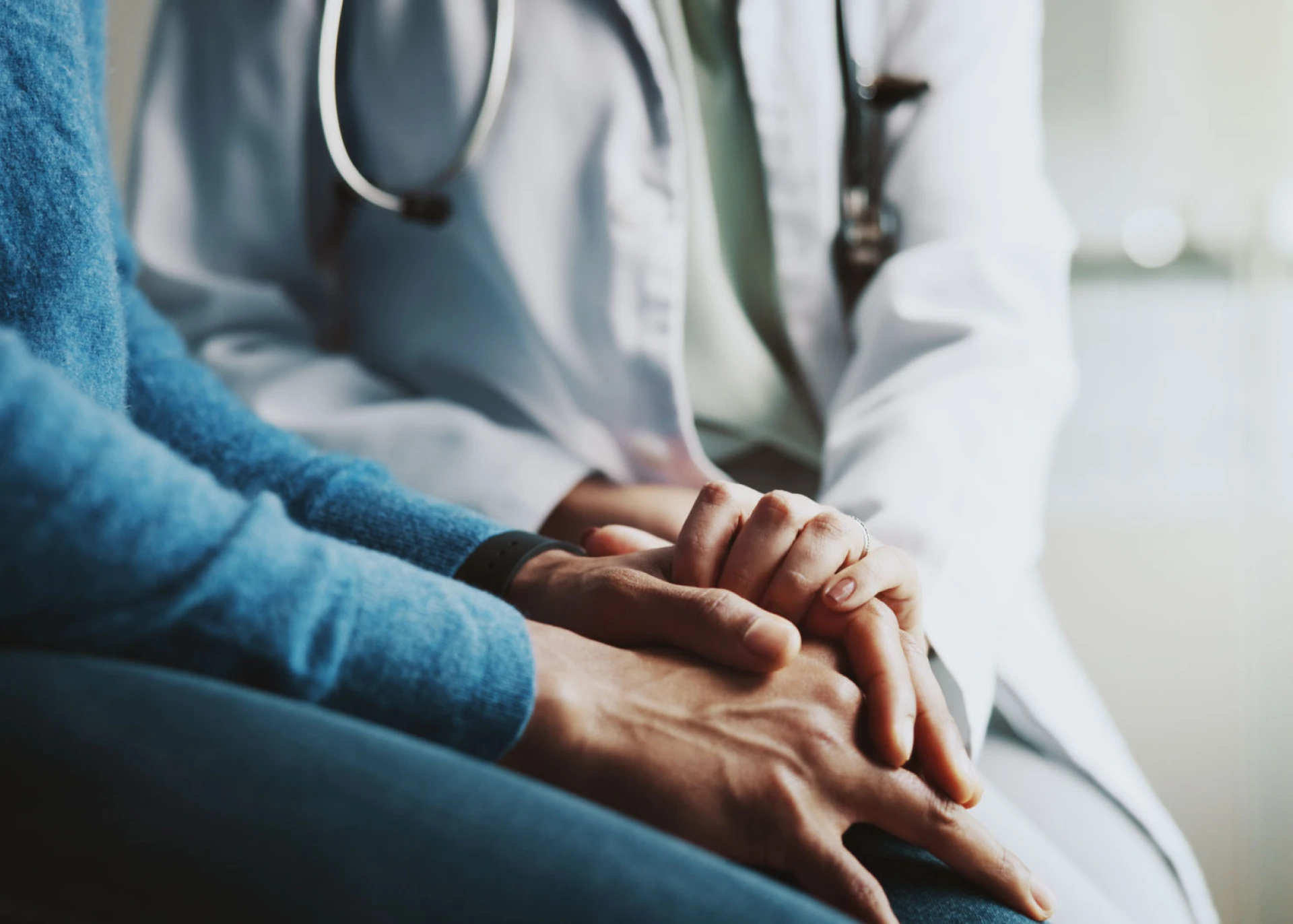 Hands showing empathy in medical setting